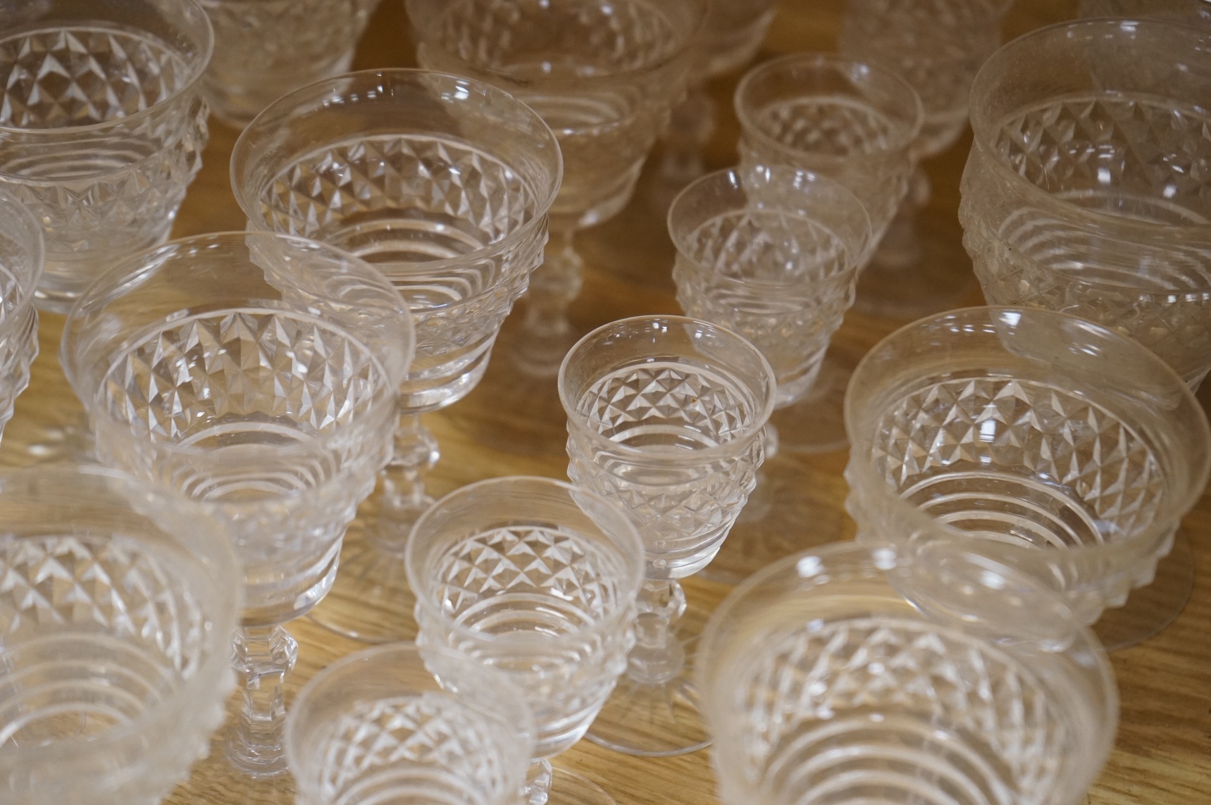 A suite of early 20th century cut table glass, custard glasses, a tall stemmed etched glass, etc., etched glass 24cm high